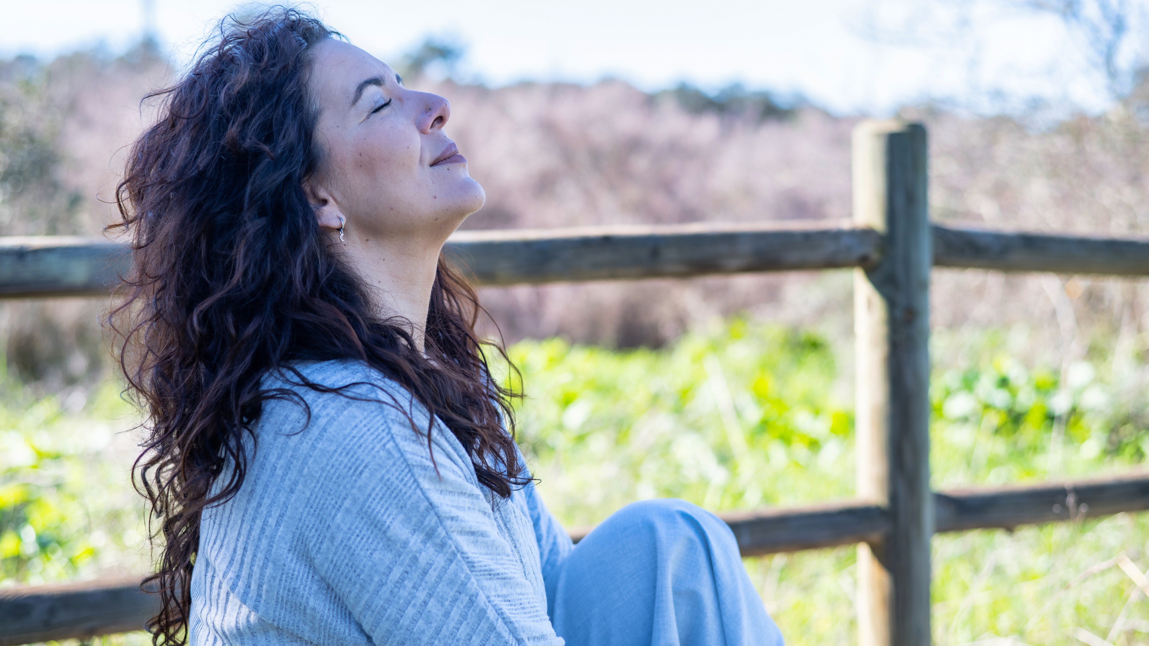Woman sitting peacefully in sunlight